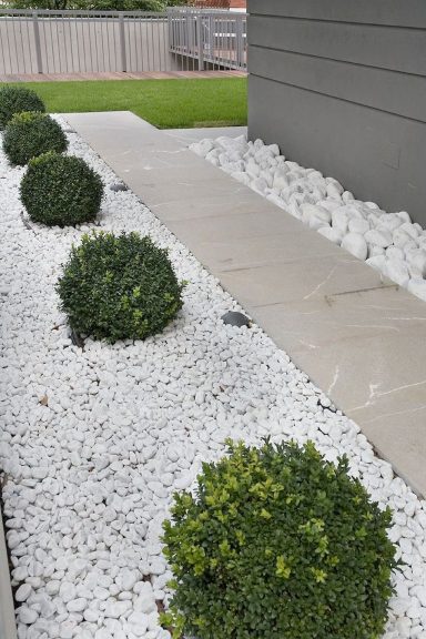 White Rock Bed Install with Rounded out Boxwoods..